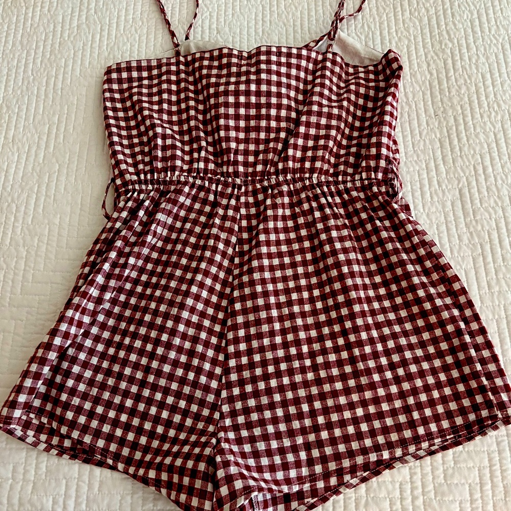 Very cute burgundy and white romper. New with tags